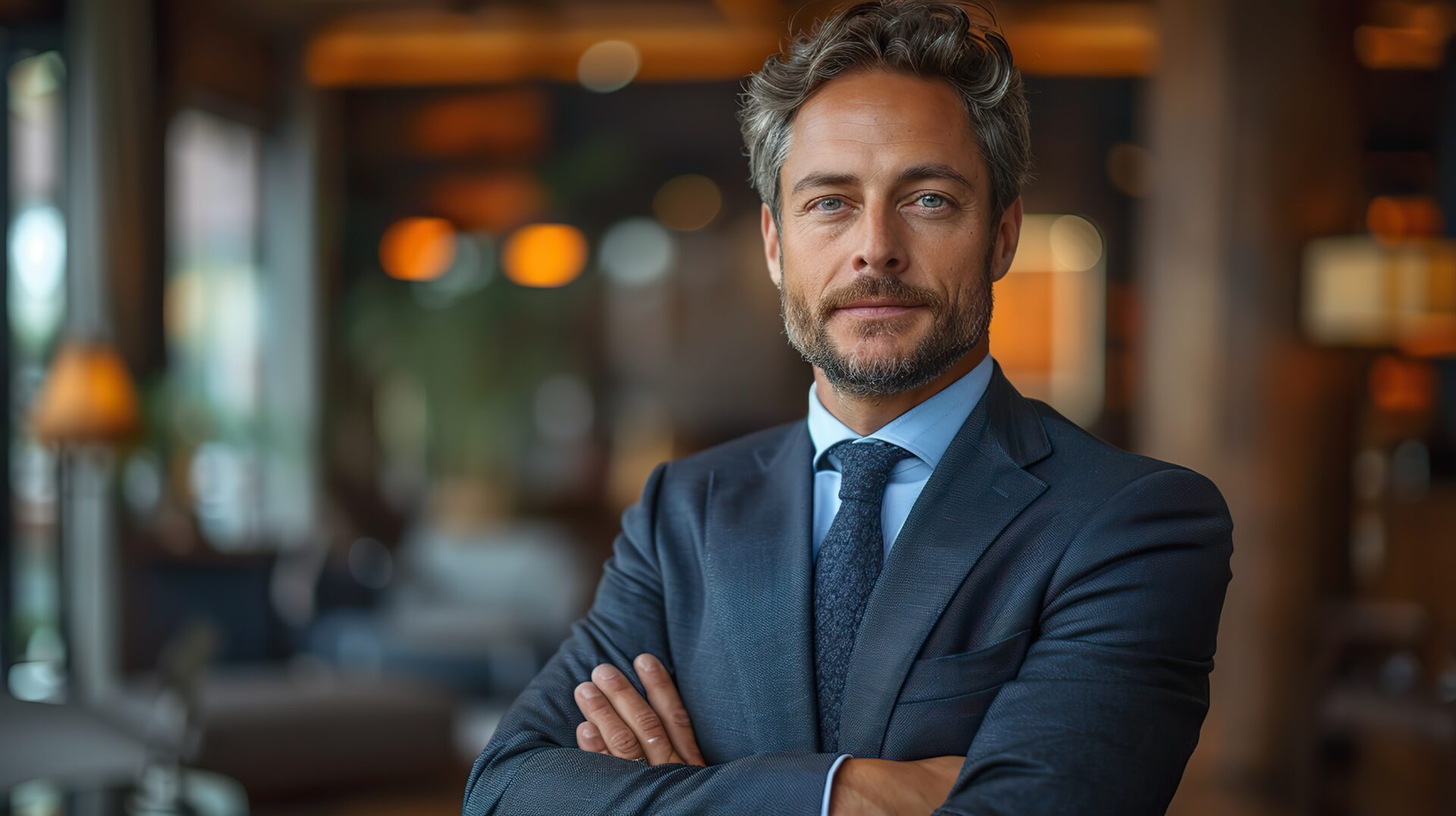 seo banker broker financial director gorgeous serious caucasian wealthy business man in a suit standing with crossed arms at office stock photo